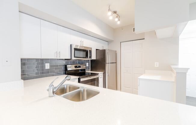 a kitchen with white countertops and stainless steel appliances at Heritage Bay, Florida, 34957