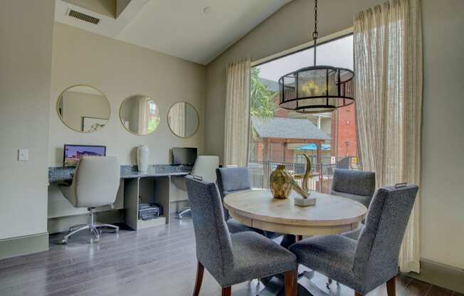 a dining area with a table and chairs and a large window