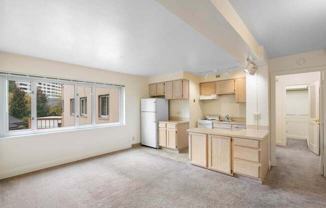 a kitchen with a large window and a sink and a refrigerator