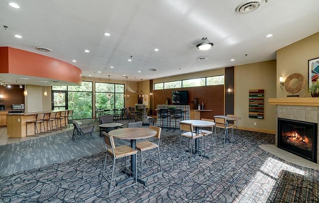 Community room with a variety of seating and tables and a large window wall