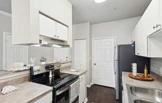 a kitchen with a stove and a refrigerator and a sink