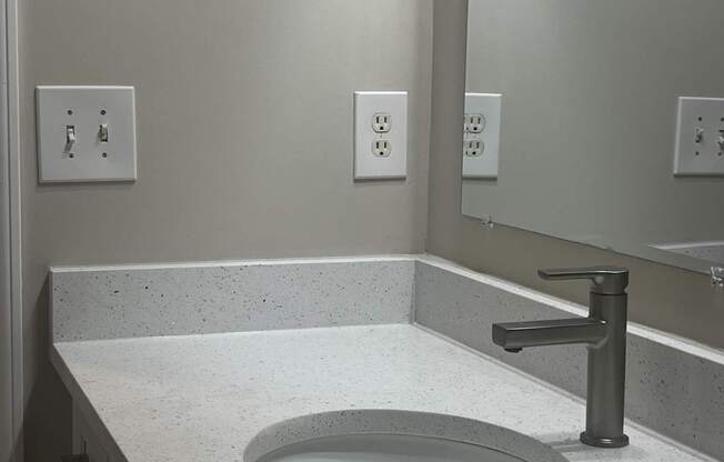 a sink and mirror in a bathroom at The Berkeley Apartments, Georgia, 30096