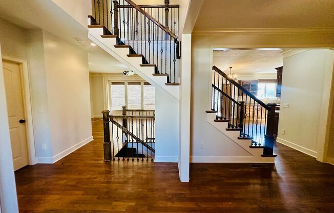 {20067} Custom Built Home in Woodland Manor + Open Main Level with Modern Lighting and Hardwood Flooring + Finished Walk Out Basement + Enclosed Sunroom + Three Car Garage + Fenced Yard