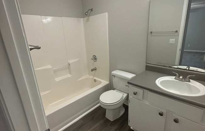 an empty bathroom with a toilet sink and bathtub