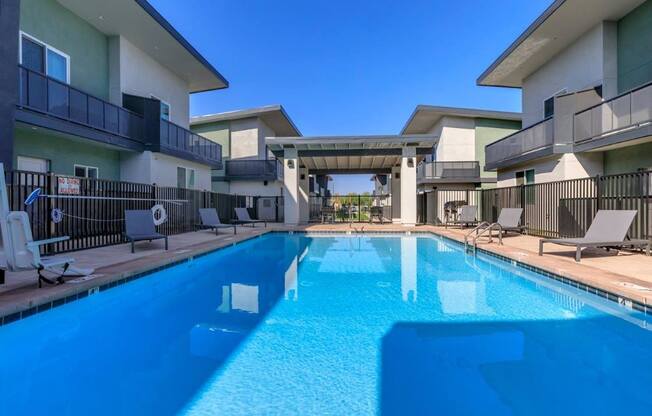 The Hedrick on Mountain Townhome-Style Apartments in Tucson, Arizona Pool with Lounge Chairs