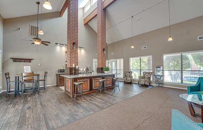 A living room with a kitchen area in the background.