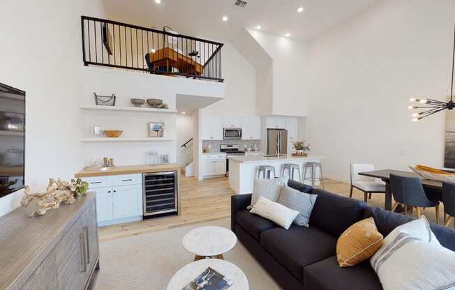 a living room with a couch and a kitchen in the background at Novella Biltmore, Phoenix