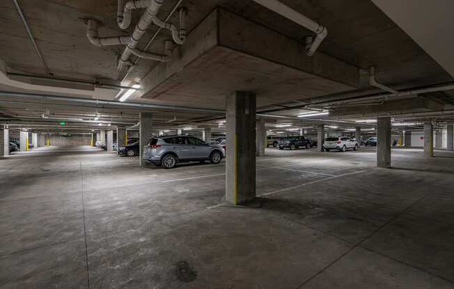 an empty parking garage with cars parked in it
