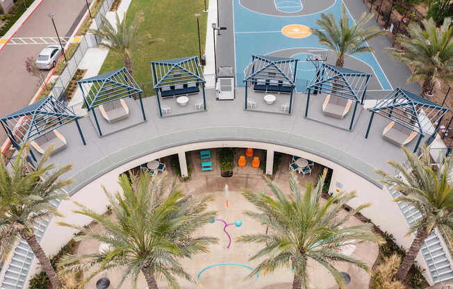 A playground with a basketball court and a slide.