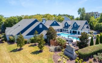 A large house with a pool in the backyard.