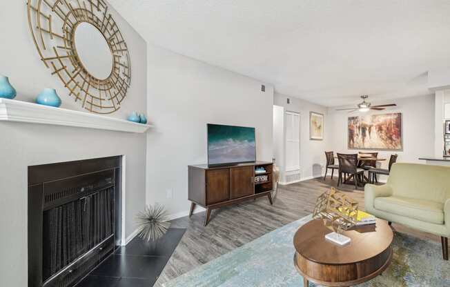 a living room with a fireplace and a tv