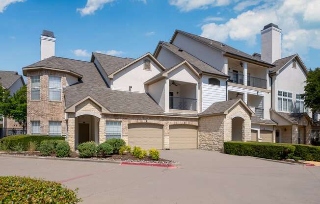 a large house with two garages in front of it