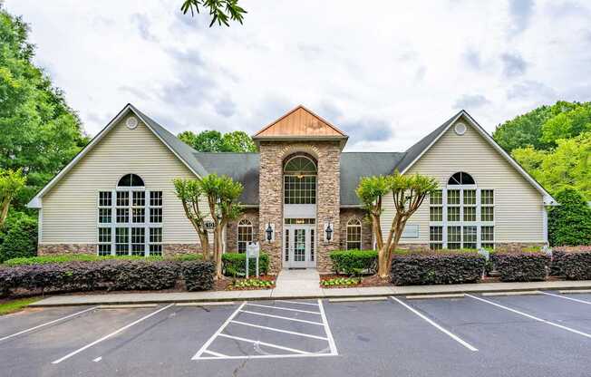 Apartment with a parking lot in front.