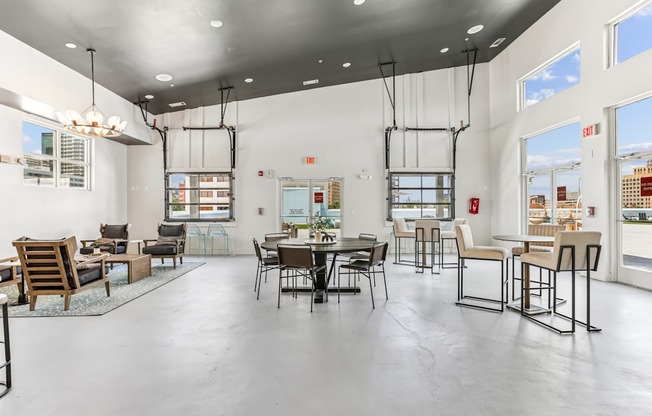 A large open space with a dining table and chairs.