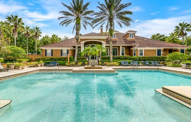 A large house with a pool in front of it.