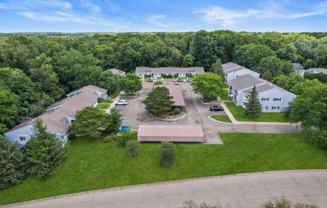 an aerial view of several houses and a parking lot