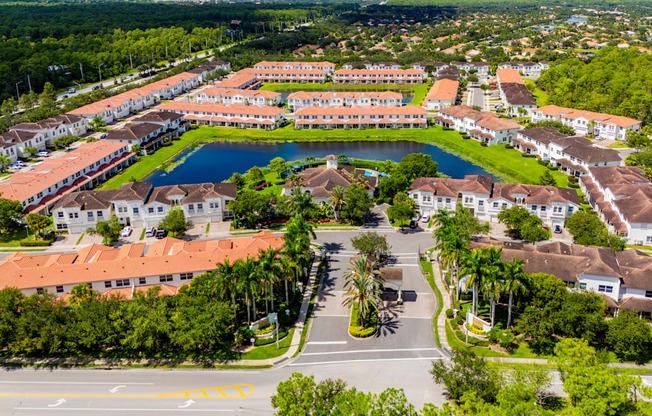 A large building complex with a pool in the middle.