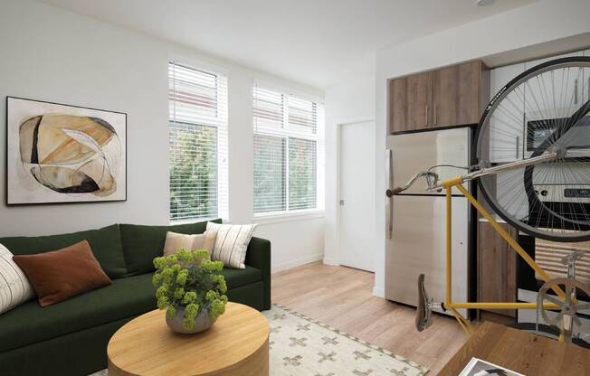 a living room with a green couch and a bicycle in the corner