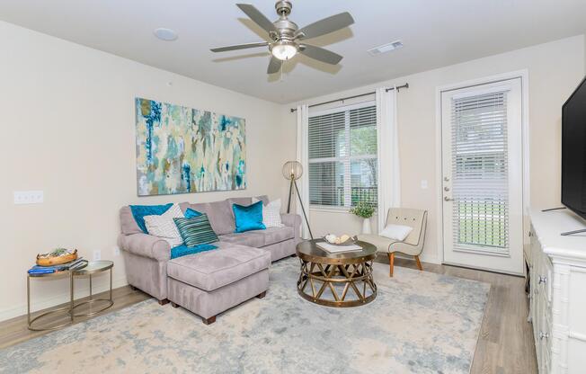 a living room filled with furniture and a large window