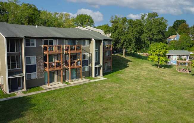 A large apartment complex with a green lawn in front.