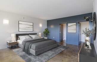 a bedroom with blue walls and a gray bed