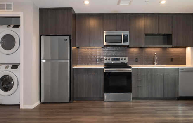 Kitchen with Stainless Steel Appliances and In-home Washer and Dryer