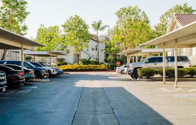 A parking lot with cars parked under a shelter.