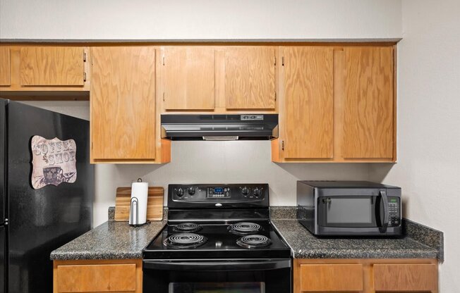 a kitchen with a stove microwave and cabinets