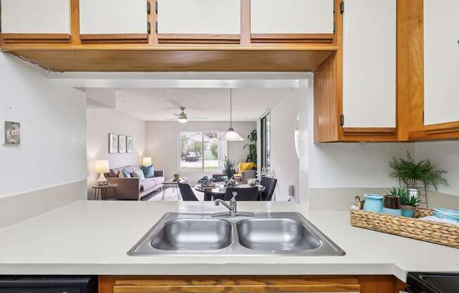 A kitchen with a sink and a microwave.