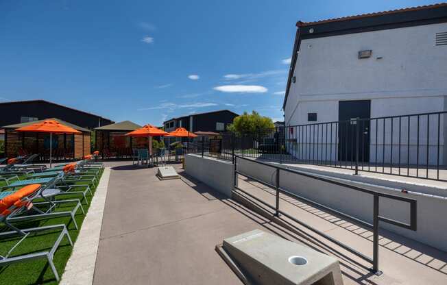 a rooftop patio with lounge chairs and umbrellas