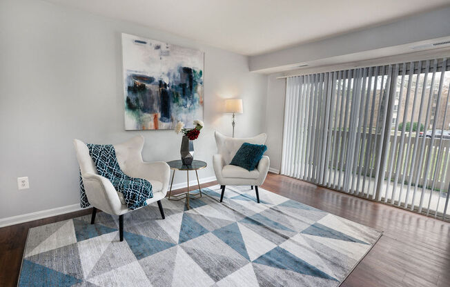 a living room with two chairs and a rug at The Glendale Residence, Lanham, MD, 20706