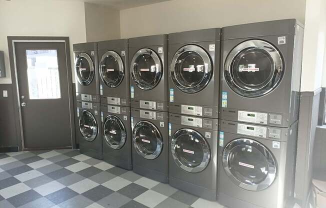 A row of washing machines in a Overlook at Pantano's Laundry Room