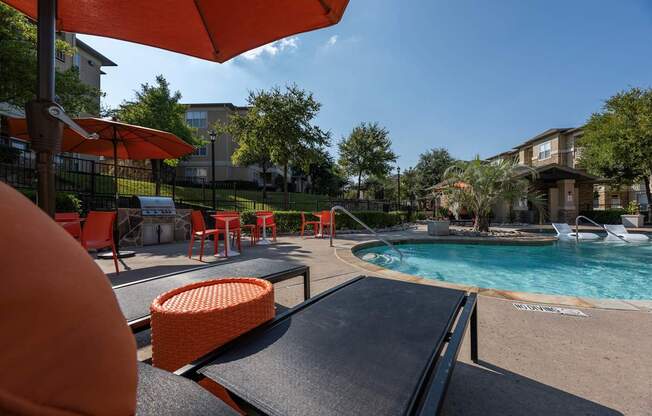 Pool area with a sun lounger at Woodbridge Villas Apartments, Texas