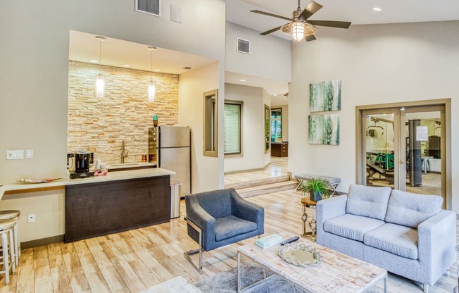 Lounge area and clubhouse kitchen space with coffee maker and fridge at Hillside Creek Apartments in Austin, TX