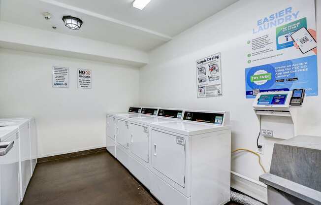 a laundry room with two washes and two washing machines