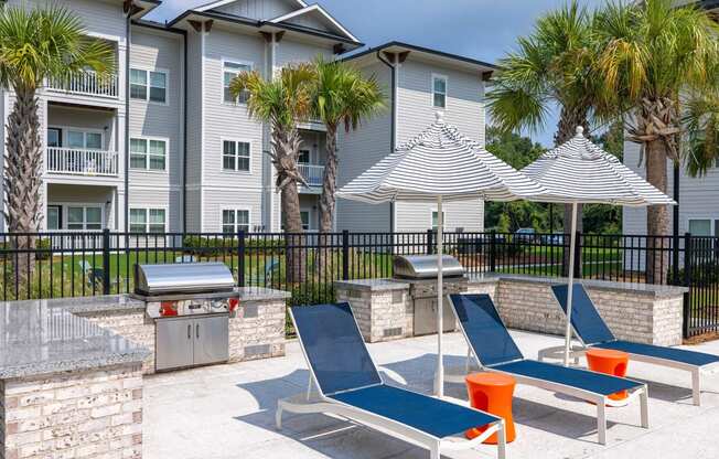 our apartments have a large patio with chairs and umbrellas