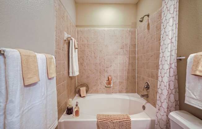 a bathroom with a large soaker tub and matching towels