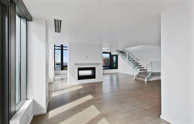 A large living room with white walls and hardwood floors at Bravern, Bellevue, Washington