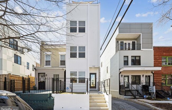 Welcome to 1181 Neal Street NE, a stunning 3-level townhome offering a private rooftop deck with breathtaking skyline views and off-street parking.