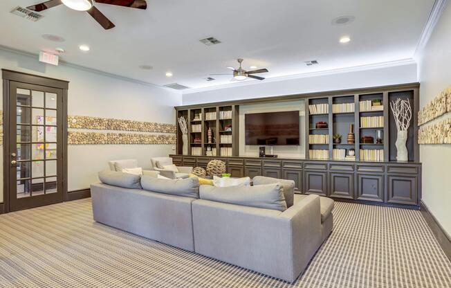 a living room filled with furniture and a large window