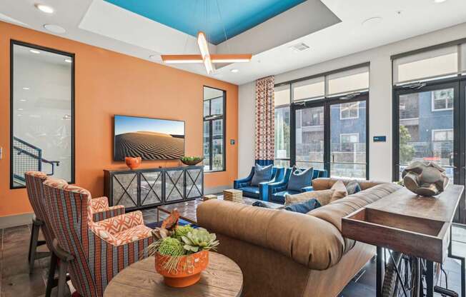 A living room with orange walls and furniture.