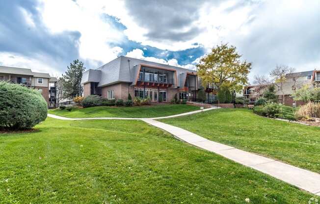 A large house with a green lawn in front.