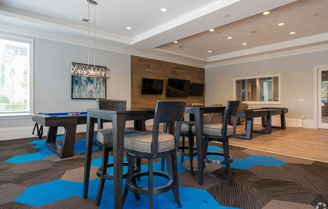 A modern dining room with a large table and chairs.