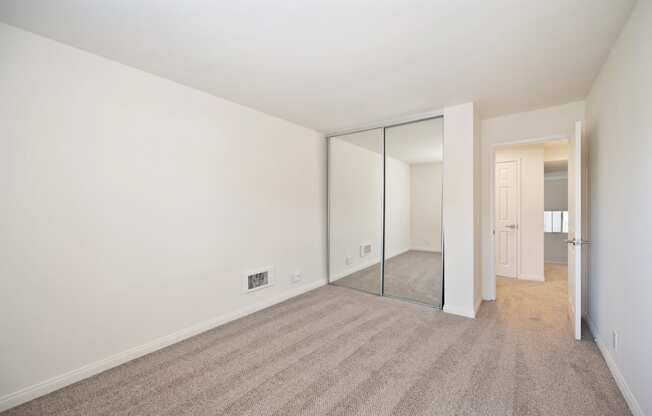 a living room with a carpet and a mirror