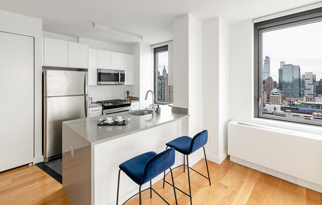 Apartment at 606 West 57th Street featuring modern kitchen with window, in-unit washer drier, and vi