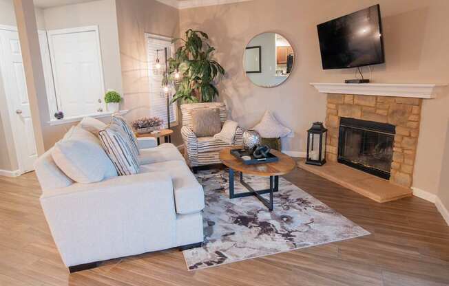 a living room with a fireplace and a tv