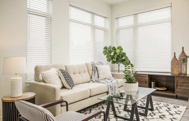 a living room with a couch and a glass table