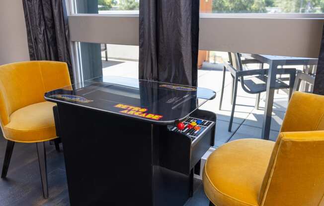 a game table in a room with yellow chairs at Solasta, Sacramento, CA, 95831