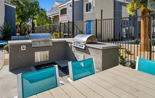 an outdoor kitchen with a grill and a bbq