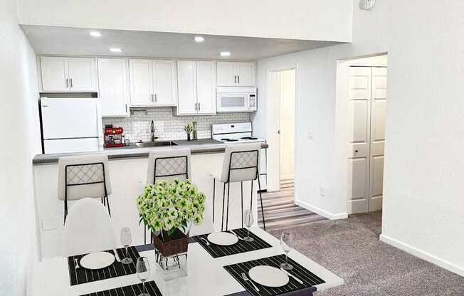 A kitchen with white cabinets and a black and white rug.